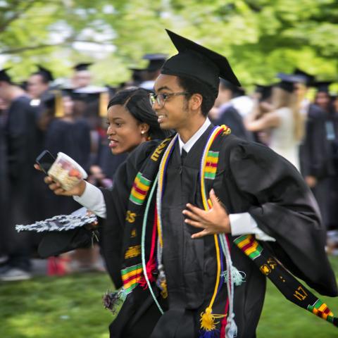 international students running at commencement