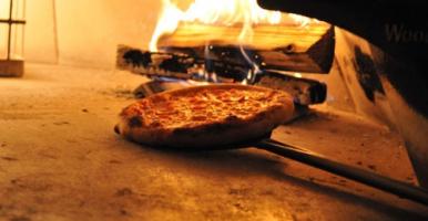 Pizza being made in the wood-fired oven at Ciao's in Ithaca.